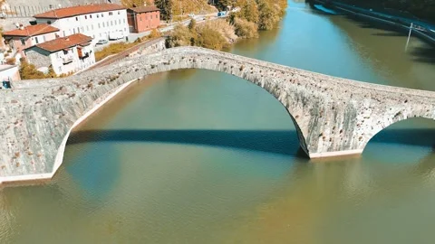 Drone perspective of historic Devils Bridge Ponte della Maddalena over Serc.. Stock Footage 336469856