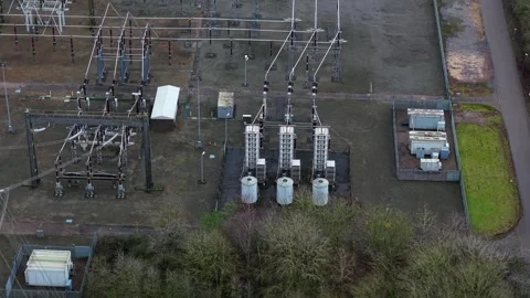Drone perspective of massive electricity towers and transformer systems at a Stock Footage 336743977