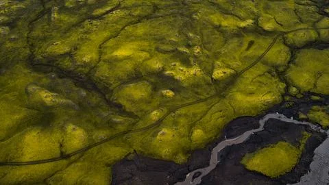 Drone perspective of moss-covered basalt terrain with dark lava formations an Stock Photos