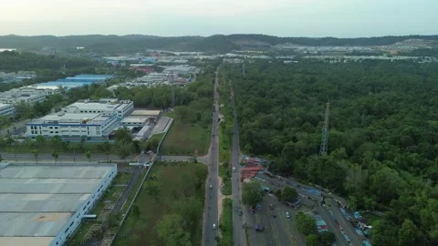 Drone perspective showcasing a long straight road cutting through lush gree.. Stock-Footage 339031633