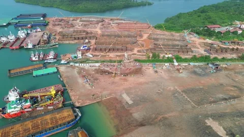 Drone perspective of a sprawling coastal shipyard, highlighting intricate v.. Stock Footage 325310161