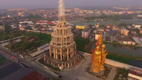 Drone perspective of temple rooftops shining under sunrise sky, Bangkok Stock Footage 304374027