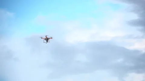 Drone Phantom 3 flying in a blue sky Stock Footage 158803857