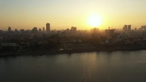 DRONE PHNOM PENH BY SUNSET Sky down to riverside and boat Mekong Vidéo 127068211