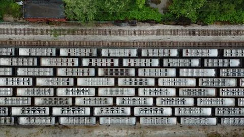 Drone photo looking down on lines of parked train cars in the train yard Stock Photos