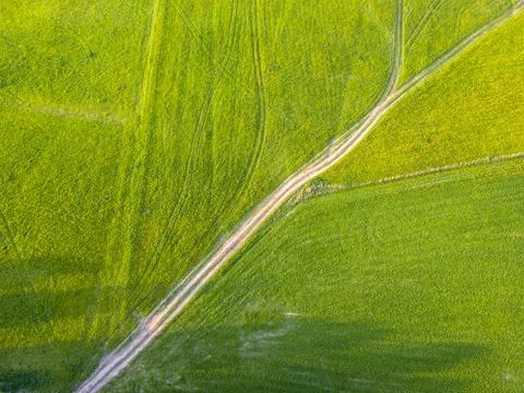 Drone Photo of the Road Between Fields in Colorful Early Spring - Surrounded Stock-Fotos