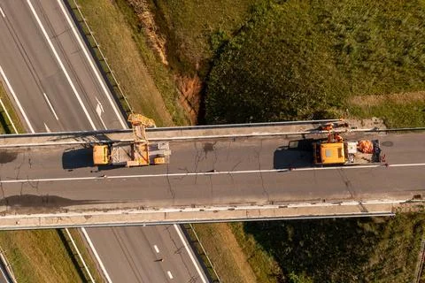 Drone photography of construction workers with a crane inspecting and repai.. Stock Photos