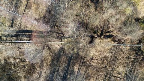 Drone photography of old pipeline going through landscape during spring day Fotos de archivo