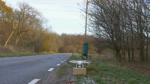 Drone pick up package and fly away Stock Footage 82538936