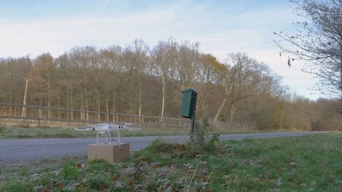 Drone pick up package and fly away Stock Footage 82539792