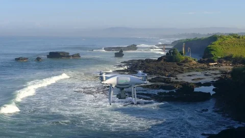 Drone pilot with high resolution camera flying over sea in bali. Stock Footage 75453795