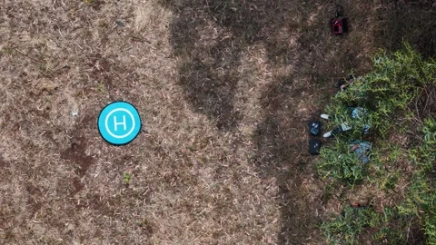 Drone pilot landing on drone pad on field Stock Footage 311589954