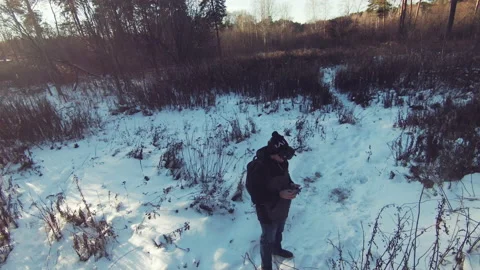 Drone pilot man with a remote control on the background of a winter forest Stock Footage 166167898