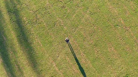 A drone pilot on a meadow from below into the sky Stockbeeldmateriaal 146476452