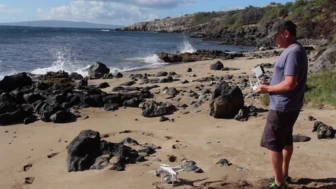Drone Pilot, Operator, Launching From Tropical Beach. Wearing a hat. Stock Footage 71811313