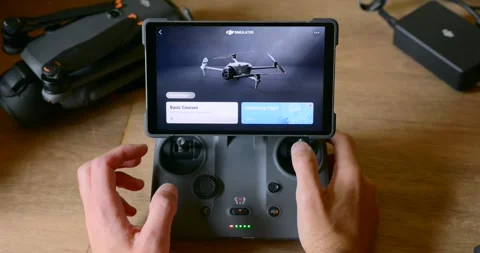 Drone Pilot Practicing Flight Simulation on Tablet Display Attached to Stock Footage 328998722