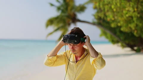Drone pilot puts on goggles for flight on fpv in maldives Stock Footage 244391415
