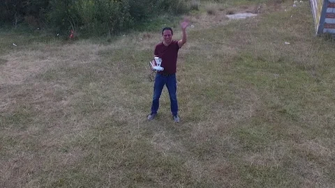 Drone pilot with remote control in hand greets the camera Stock Footage 241531781