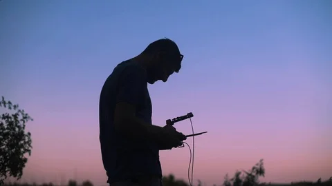 A drone pilot at sunset Stock Footage 130090916
