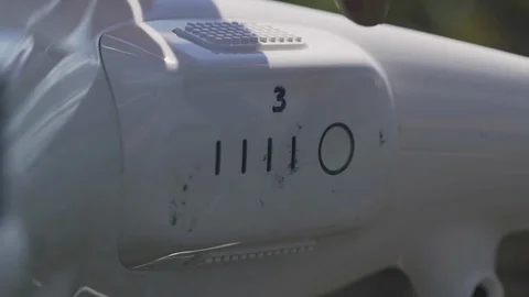 Drone pilot turn on white drone outdoors Stock Footage 129272200