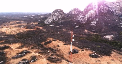 Drone point of interest of a mobile antenna surround by rocks, Brazil.  Video stock 99569607
