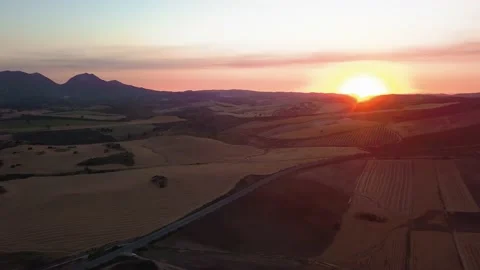 Drone point of road on mountain by river against cloudy sky during sunset Stock Footage 130313534