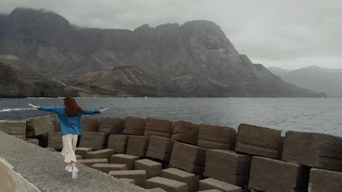 Drone point of view - cheerful young girl jumping and having fun on the Vídeo Stock 112355013