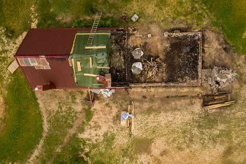 Drone point of view of half burned down house Stock Photos