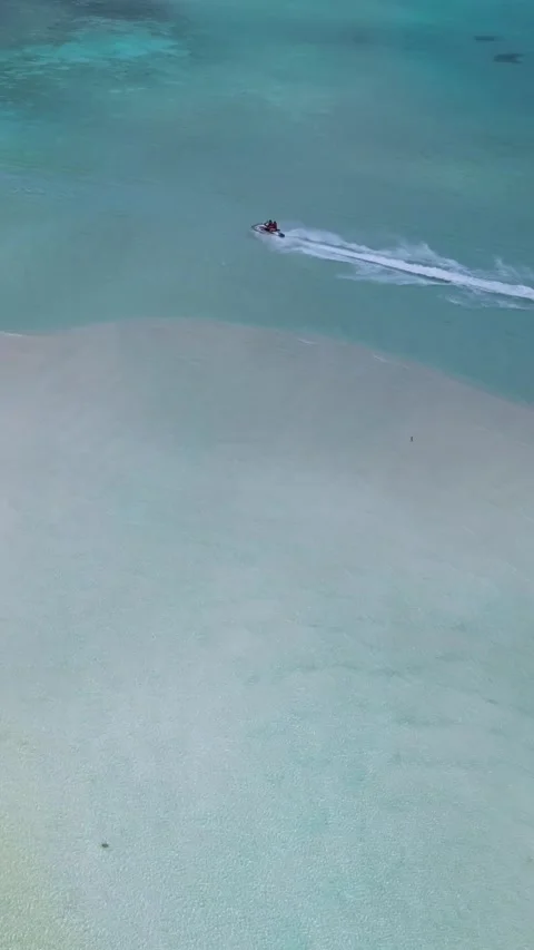 Drone point view at jet ski in the sea near sandbank.Vertical video Stock Footage 305913676