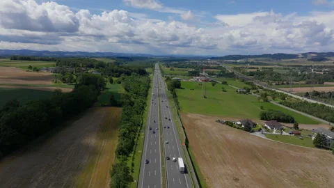 Drone progression over autobahn amid Austrian-German meadows Stock Footage 264002822