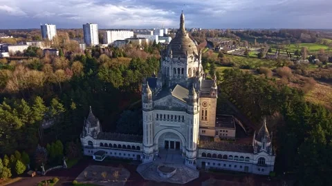 Drone pull away from Basilique Sainte Thérèse de Lisieux with forest park and Vídeo Stock 328142993