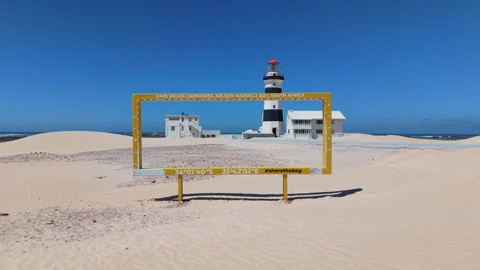 Drone Pull-Away from Lighthouse and Rise Up Revealing Ocean, Beach, Sand, Blue S Stock Footage 306302358