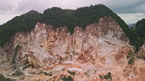 Drone pull-away over limestone quarry, mogotes and industrial scars, Malaysia Stock Footage 316691737