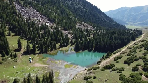 Drone Pull Away From River And Mountain Camp. Kyrgyzstan, Suttuu-Bulak Lake. Stock-Footage 332787331
