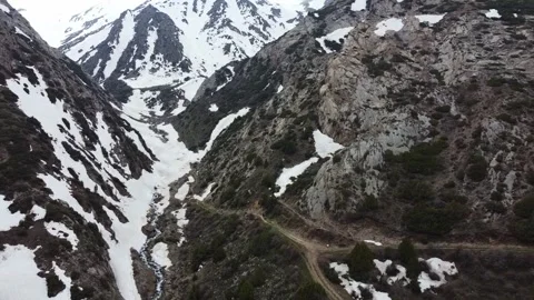 Drone Pull Away From Snowy Gorge And Road Junction. Kazakhstan, Sayram-Ugam Park Stock-Footage 332936753