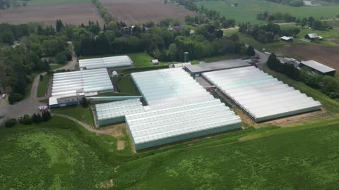 Drone -Pull Away View with Tilt up - Greenhouses Property Stock Footage 314227663