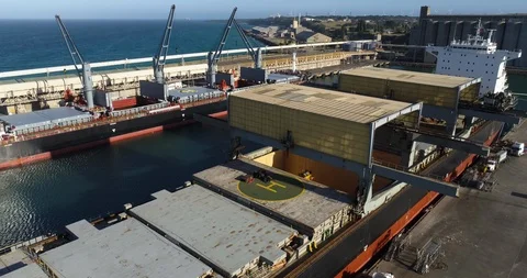 Drone pull-back of aluminum ingots being loaded onto a ship in Australia. Stock Footage 86851107