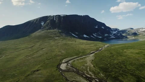 Drone Pull Back: Blahoa Mountain and Lake Blahotjonna, Trollheimen Norway Stock Footage 329305376