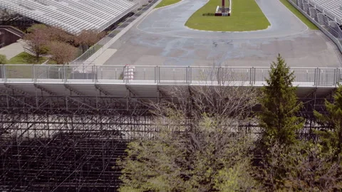 Drone pull back dolly shot on empty racetrack &amp; bleachers Stock Footage 167777550