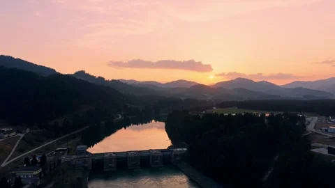 Drone pull back from hydroelectric dam at sunset Stock Footage 330545974