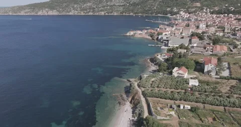 Drone Pull Back: Komiža &amp; Boat Entering Harbor, Vis Island, Croatia Video stock 313483171
