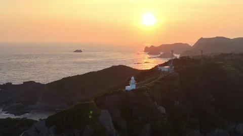 Drone Pull Back from Lighthouse to Wide Cape Sunset│4K Aerial Stock Footage 326082068