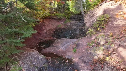 Drone Pull Back To Reveal A Stream Waterfall Running Through Red Rocks Stock Footage 315265597