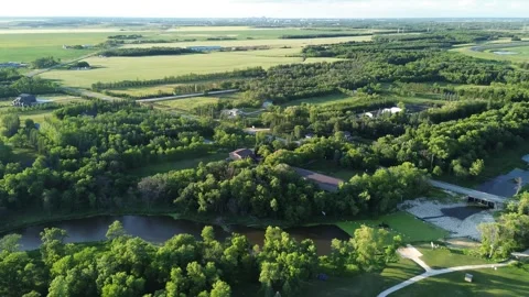 Drone pull-back revealing a vast rural landscape with river and fields. Stock Footage 312528007