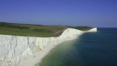 A drone pull back shot of Seven Sisters White Cliffs in Eastbourne, UK Stock Footage 131417427