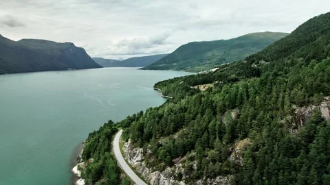Drone Pull Back: Turquoise Eresfjord Norway with Coastal Road and Mountains Stock Footage 330130778