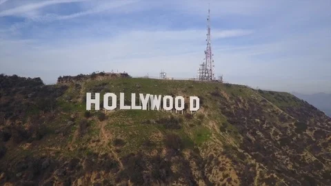 Drone pull back view of famous Hollywood Sign on hill in Los Angeles, CA Stock Footage 99829951