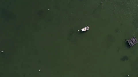 Drone pull out above shallow bay and empty water Stock Footage 299769125