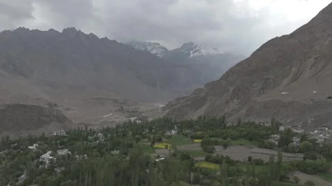 Drone Pull Out Revealing Ladakh Village Surrounded by Forest and Mountains with Stock Footage 334656278