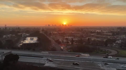 Drone Pull Out from Sacramento Skyline at Sunrise Revealing Freeway and City 4K Vídeos de archivo 330566899